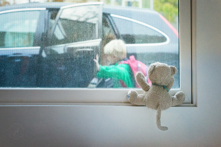 A stuffed animal watches as his boy leaves for kindergarten.