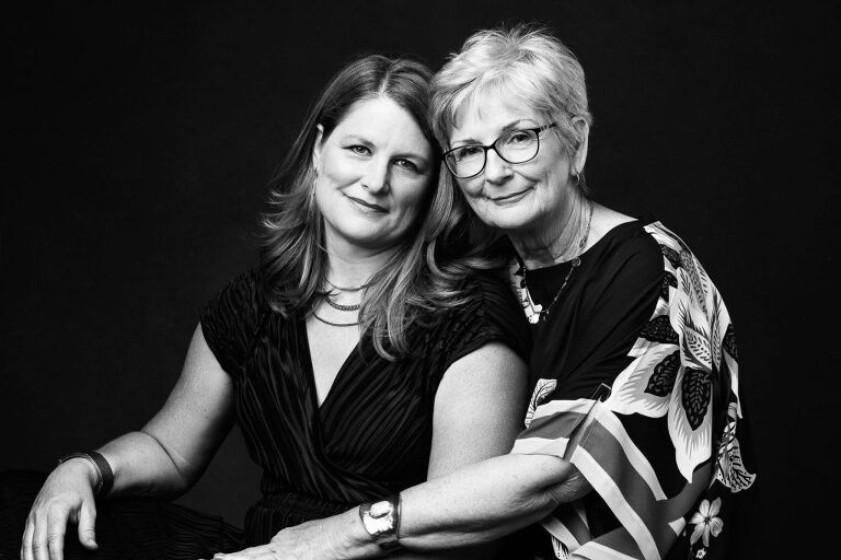 Black and white photograph of a mother and daughter during their professional photo session.
