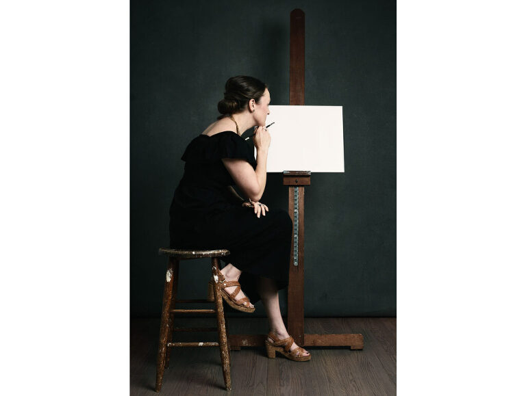 Portrait of an artist, readying to start on a blank canvas.